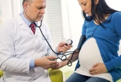 Doctor measures the blood pressure of a pregnant woman