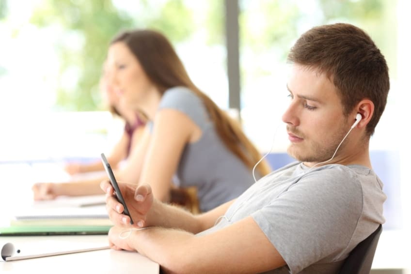 A distracted student listens to music in a classroom. Attention-deficit hyperactivity disorder (ADHD) is a group of behaviors that makes it difficult to pay attention at school, work, or home.
