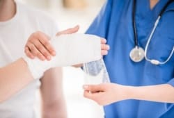 A doctor bandaging a patients hand to prevent a skin infection. Cellulitis is a skin infection caused by bacteria. It can spread to your lymph nodes and cause a blood infection if not treated.