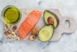 Salmon, nuts and a sliced avocado laid out on a cutting board. The keto diet, or ketogenic diet, is one that is high in fat intake and low in carbohydrate intake. This diet is not ideal for everyone.