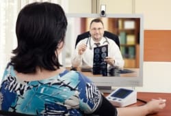 a woman using telemedicine to speak with a doctor
