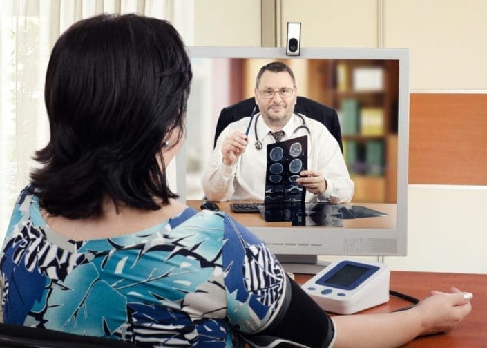 a woman using telemedicine to speak with a doctor