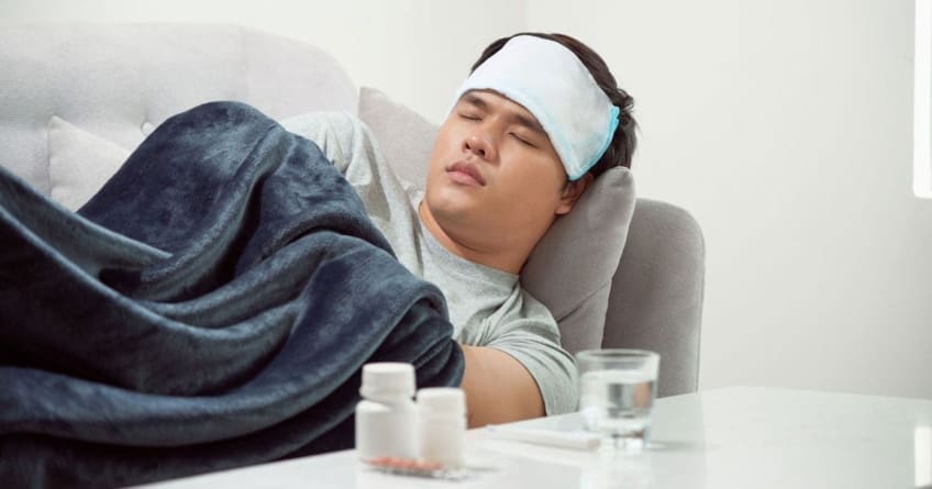 A sick man sleeps on the couch next to a table with medication and a glass of water. These days, when you’re feeling under the weather with a fever, body aches, and other symptoms, you may wonder whether you have season influenza (flu) or COVID-19. The two share many similarities, but there are a few differences.