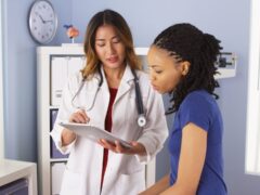 female doctor explains issues to a female patient in a doctor's office