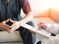 Urologist Doctor giving consult for prostate problems to patient. Urologic oncologists specialize in treating cancer of the urinary tract and male reproductive organs. Mens health problem concept.