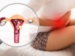 Endometriosis, virtual model of the uterus, close-up. Woman suffering from menstrual pain, while sitting on bed. Stomach pain
