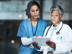 Doctors, women and digital tablet for night teamwork, medical research or surgery planning in wellness hospital. Thinking, healthcare and worker nurse in collaboration on technology for late schedule