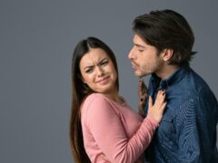 Fear Of Coronavirus Spread. Displeased Young Woman Rejecting Kisses From Her Boyfriend, Afraid Of Respiratory Infections