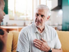 Mature man, nurse and stethoscope for checkup of cardiology, medical service and healthcare advice. Caregiver, patient and explaining symptoms for consultation, monitor breathe and treatment at house