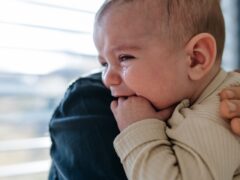Father comforting his crying baby son.