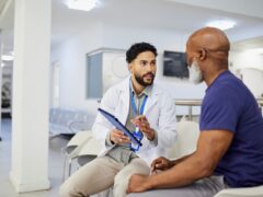 Photo of a physician going through test results with a patient.